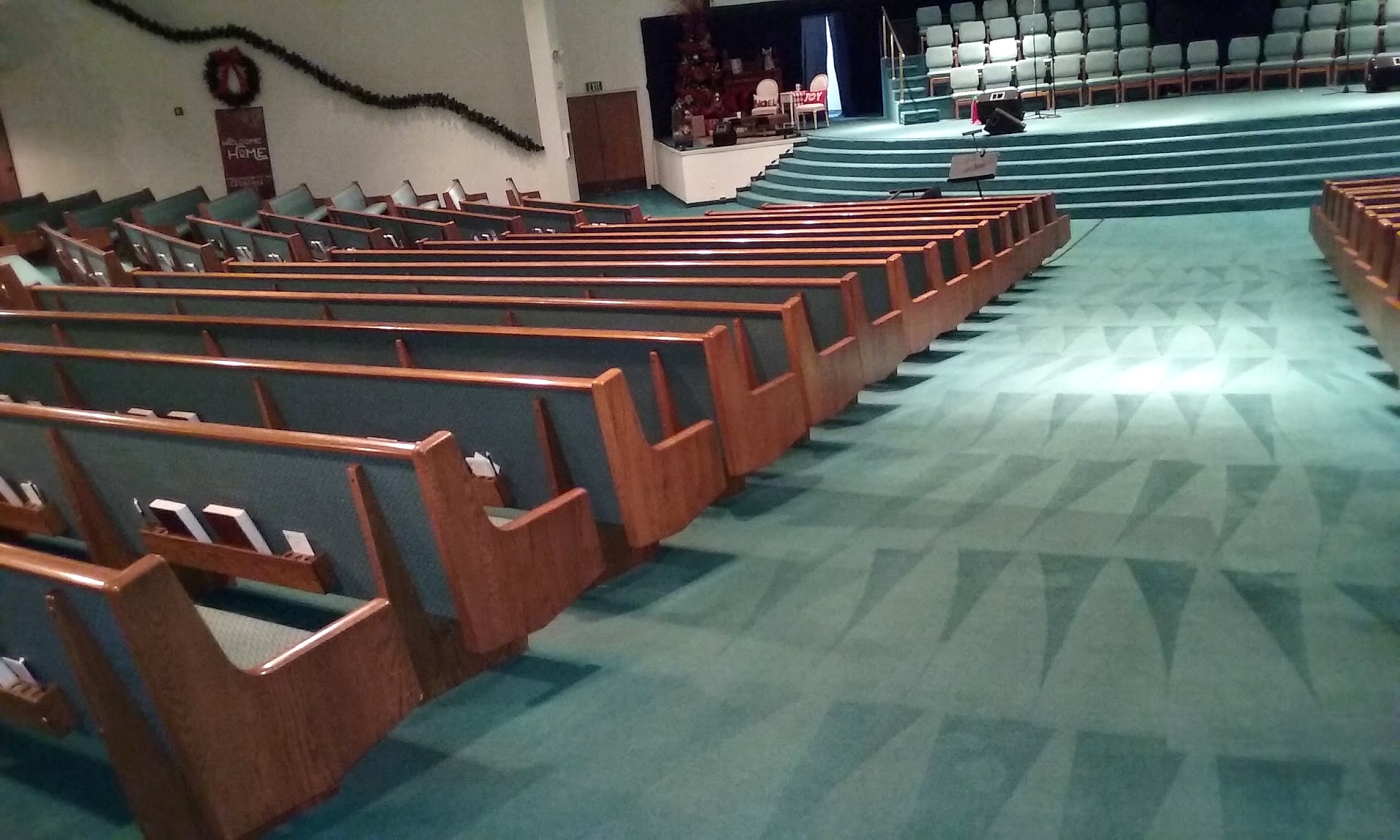 Church sanctuary pews above freshly cleaned carpet