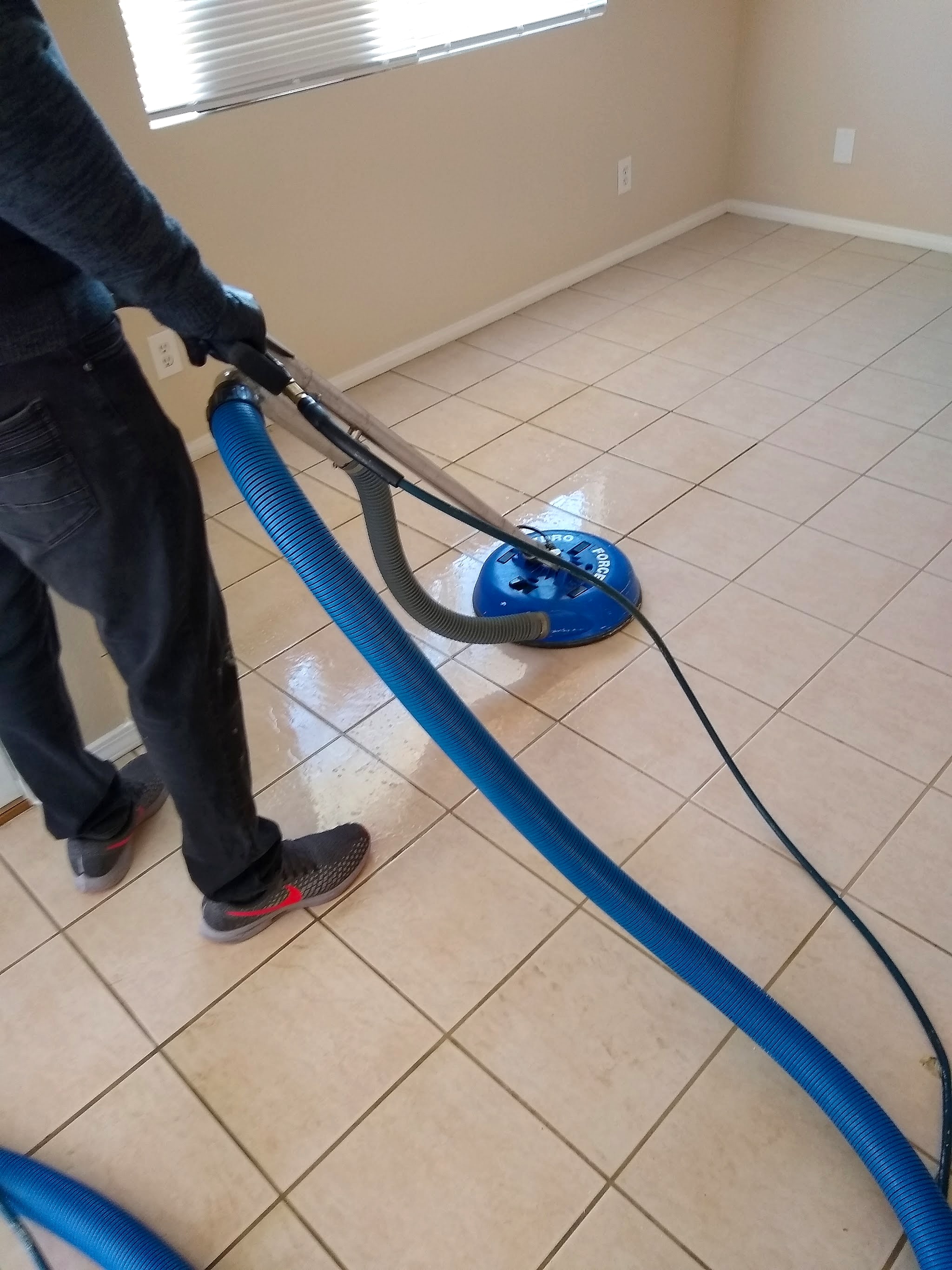 Steam cleaning a tile floor with the spinner tool