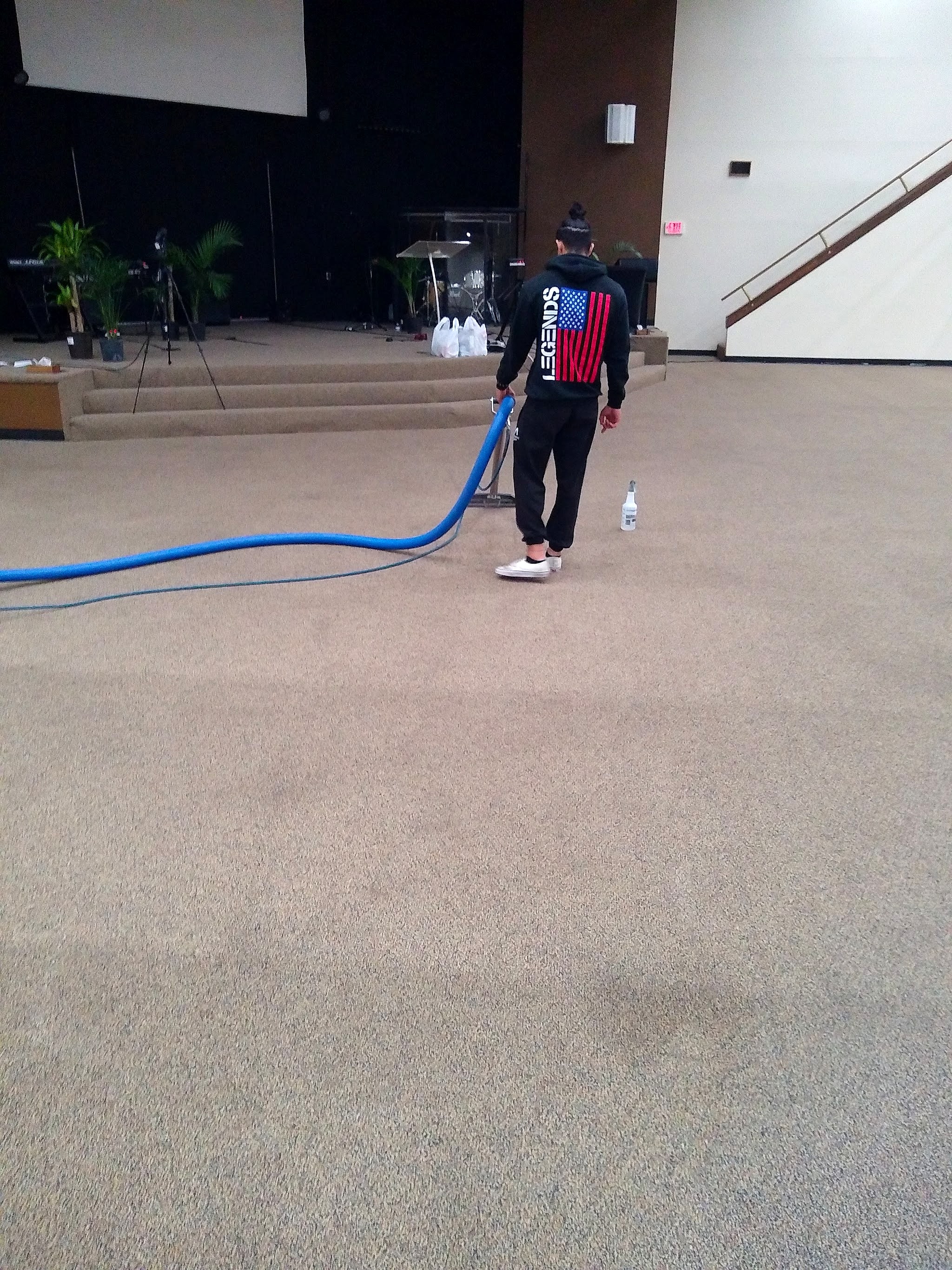 Cleaning the carpet of a large church hall